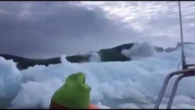 Small Boat Races to Escape a Huge Tsunami Caused by Collapsing Iceberg