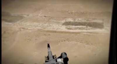 A machine gunner fires at a fleeing ISIS pickup truck. Anbar desert, 2020