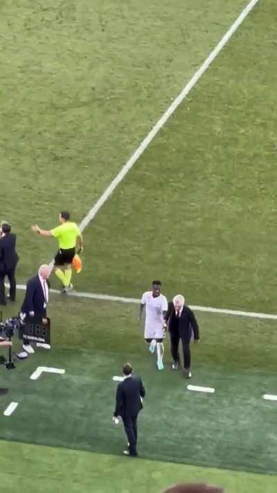 Football player was taking too long to walk off the pitch after being substituted so his manager took his hand and helped him off so the game could continue