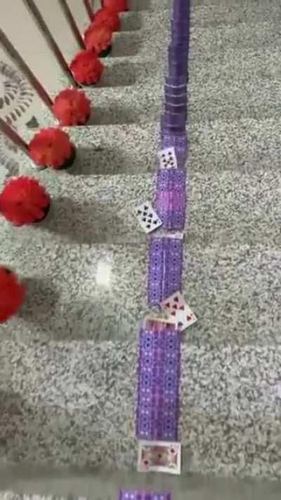 An elaborate setup of Playing cards falling like dominoes