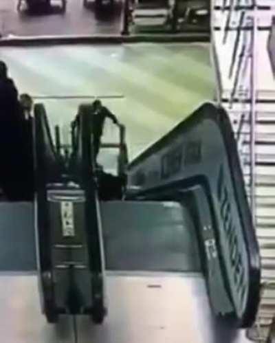 Little girl pushing brother in stroller fall down escalator in Russia
