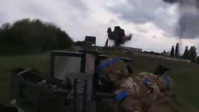 Ukrainian troops in a Mk 19 Humvee approaching a village outskirts while it's being hit by artillery