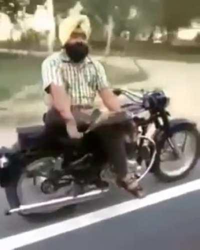 reading a book with both hands sitting sideways (60kmph)