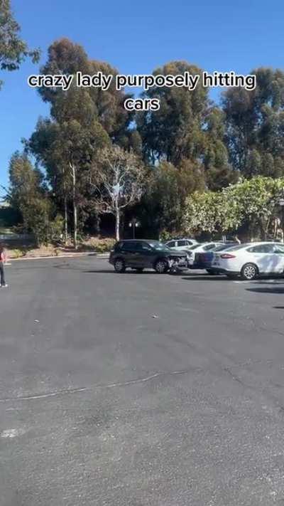 Lady purposely crashing into cars in the parking lot