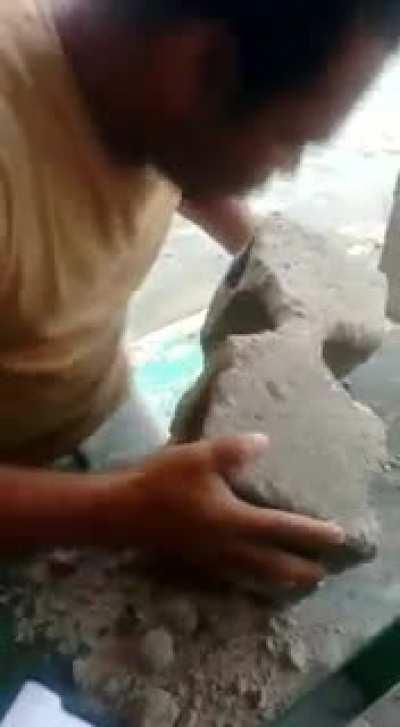 Dude eats concrete block!