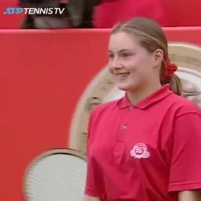 Goran Ivanišević hands his racquet to a 14-yearl-old ball girl after he's unable to face his opposition.