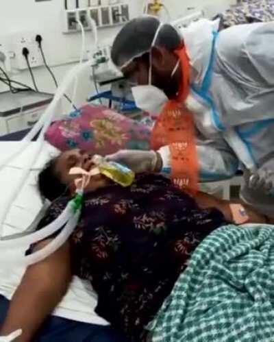 BJP politician feeding gaumutra to a covid patient on a ventilator.
