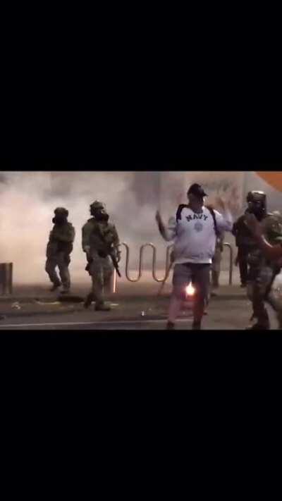 This person watching not participating in a protest being attacked for doing nothing. He ended up with a broken hand.