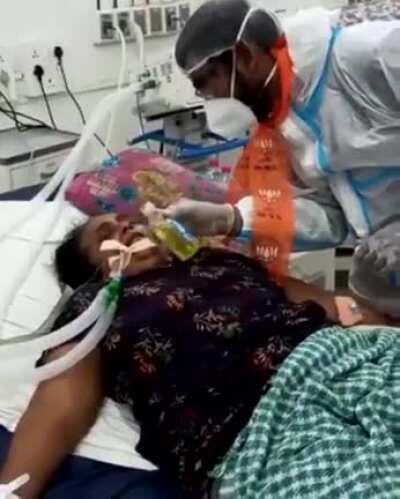 BJP politician feeding gaumutra to a serious covid patient on ventilator.