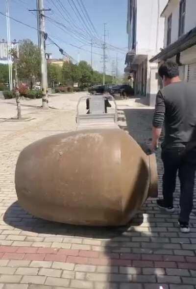 My first thought was that this is absolutely a three man job. My second thought was that there is indeed a third man, standing about like a spare prick, filming the whole thing.