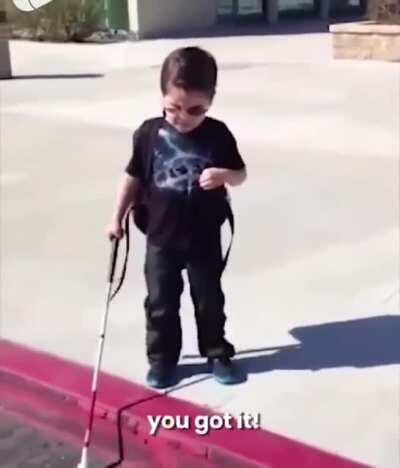 Blind little boy learning to use his cane for the first time