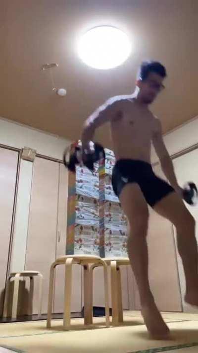 This man jumping over an approx 5ft stack of tissue boxes from a seated position