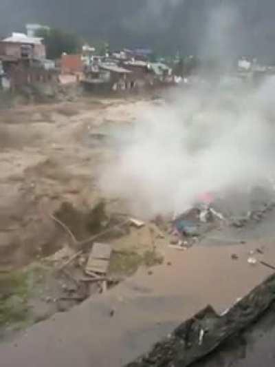 building washed away by flood in Pakistan