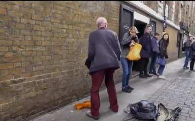 Trying to take a short cut behind a street performer