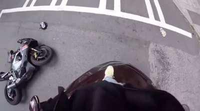 Motorcyclist crashes into car after the driver was on his phone and making the wrong turn.