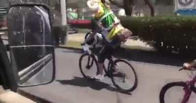 Riding a bike with a big Jesus statue and not looking where your going