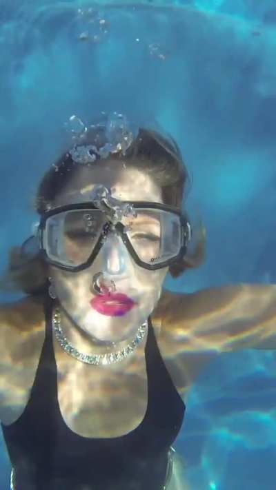 Woman blowing lots of pretty bubbles