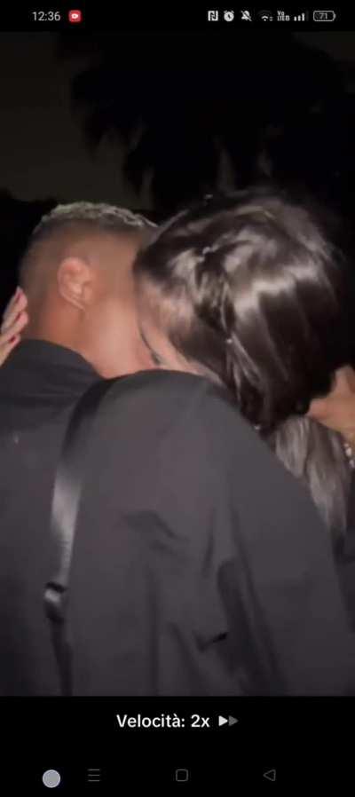 Brazilian black gay guy tongue kisses a girl at party