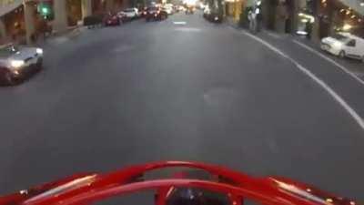 Motorcyclist gets hit by a car running a red light, flips in the air, and lands on his feet