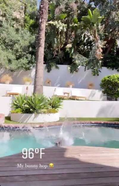 Topless jumping in her pool