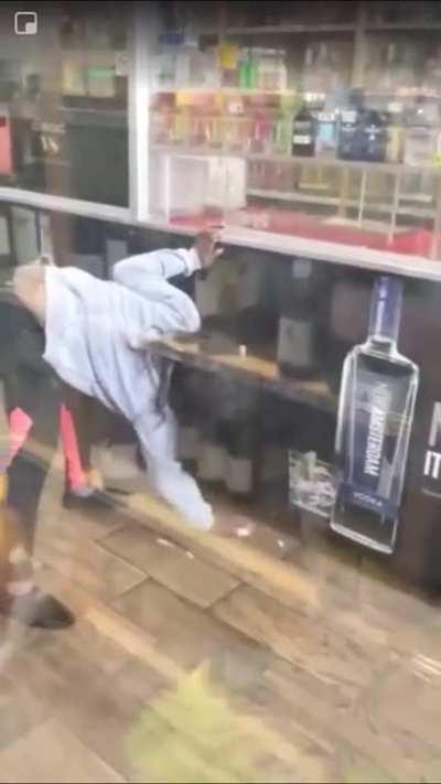 NSFW: Wretched woman urinates inside liquor store without shame.