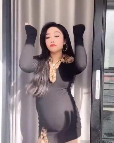 Pregnant asian hottie dancing in a tight dress.
