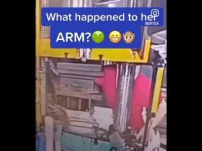 Woman puts her arm into stamping machine