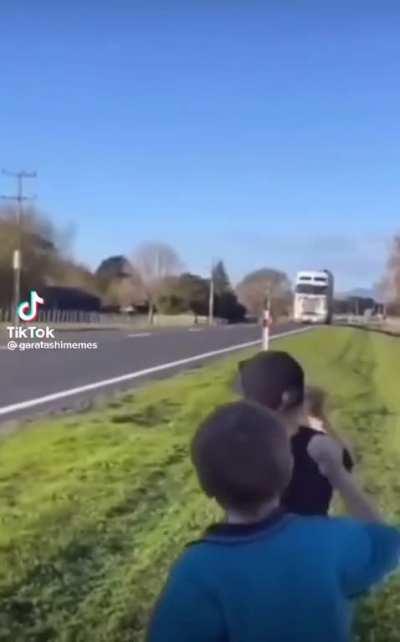 Kids encouraging this truck driver to honk his horn