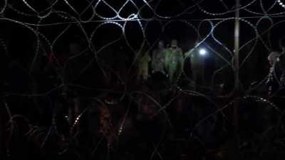 Belarussian soldiers forcing women and kids in front of the border fence (on their side) to record a propapaganda video on how badly they need help (via @mon_gov_pl)