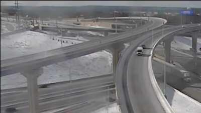 Truck misses exit ramp on bridge.