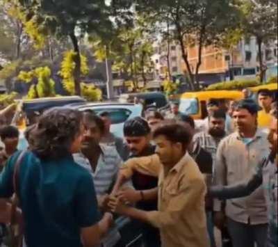 People on the street attack activist who tries to stop Scooter rider on the wrong side of the road.