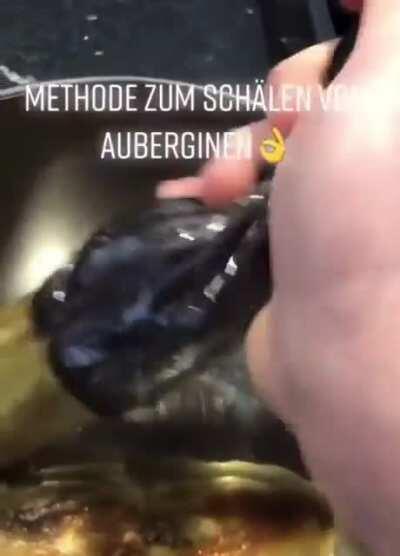 Peeling off the skin of aubergines / eggplants