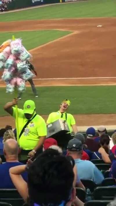 Vendor at a baseball game yells about hot dogs