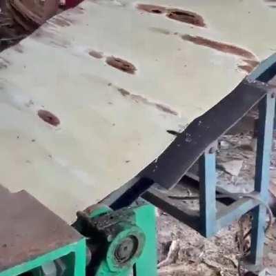 Peeling a log into veneers. Plywood results when they are press-glued together