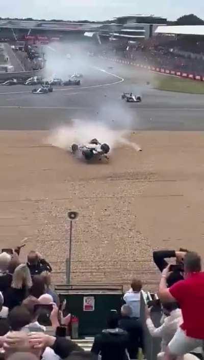 Zhou Guanyu crash at F1 British GP few moments ago. Don't know what will happen if the halo didn't exist on the car. He's safe and conscious after the crash.