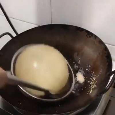 Making Bhatoora (deep-fried leavened bread)