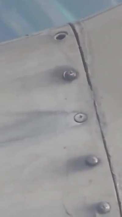 Passenger in airplane noticed their plane wing got some loose bolts.