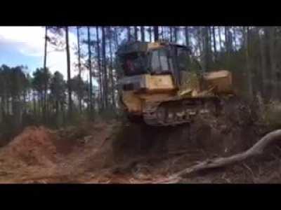 Guys backs a Dozer off a Hill...Flips Dozer Over.