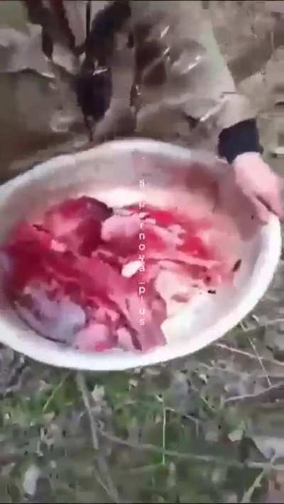 Russian Soldiers carrying back stolen butchered cow.