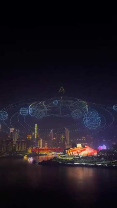 A stunning drone animation blending a peacock and a dancer in the Chongqing night sky
