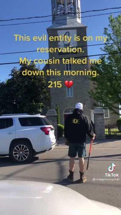 Indigenous man comes to a church with a sledgehammer to do some damage. Another man sees him and talks him down from doing something he would later regret.