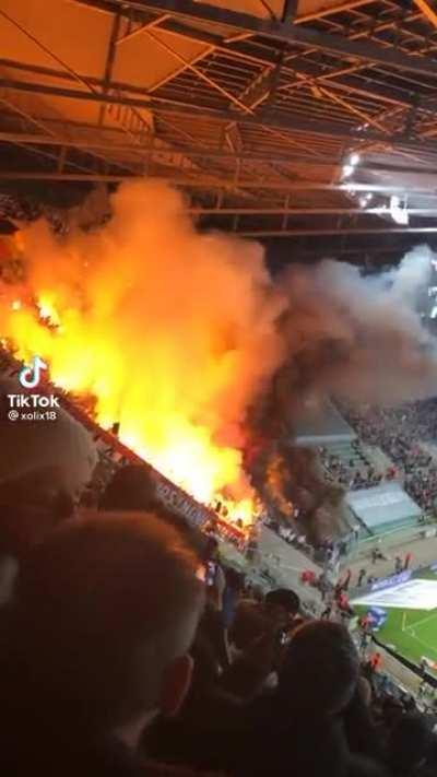 A fire rages while fans don’t seem to be phased