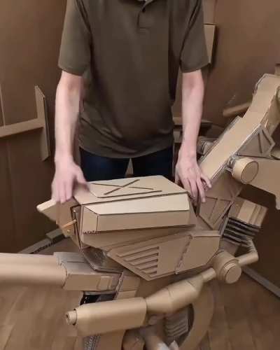 A man made cardboard's futuristic looking weapons