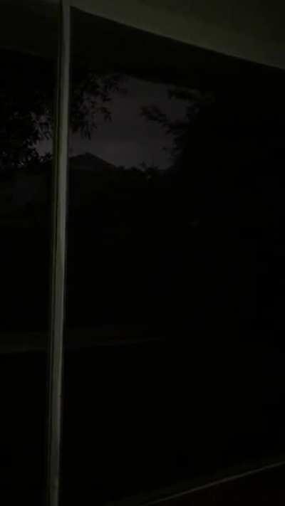 Dark rainstorm on an old Florida lanai with low lying thunder, and anoles/frogs you can’t see on the screen