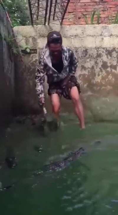 What is he holding with his left hand