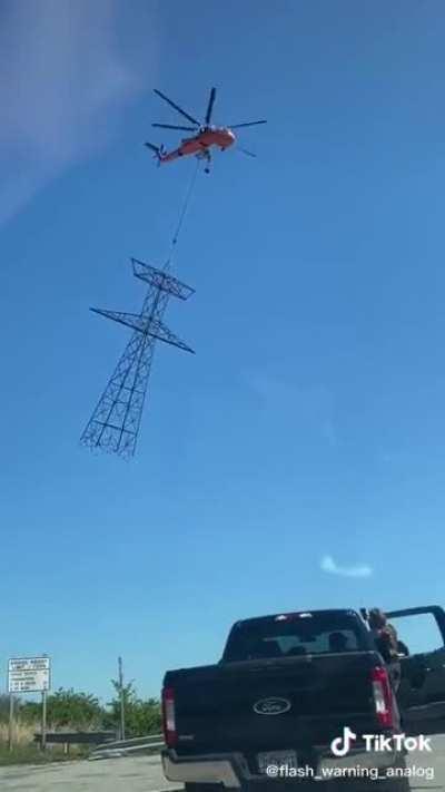 Sikorsky S-64 Skycrane lifts a high voltage powergrid piece