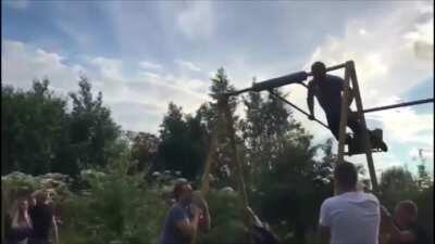 Man does an 360 on a child's swing but doesn't stick the landing