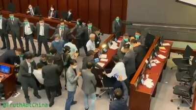 Security guards drag several pro-democracy lawmakers from the Hong Kong legislature. After 9+ pro-democracy lawmakers are forcibly removed, the vote procedes. Pro-communist Starry Lee is unanimously elected as chairperson.