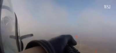 A crew member of a Yak-52 PS aircraft of the shoots down a Russian reconnaissance UAV Orlan-10 with a rifle, in the skies over southern Ukraine.