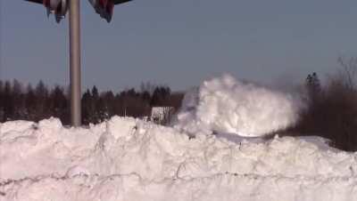 Train blasting through snow